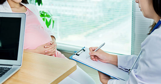 Pella Regional Health Center- A doctor examining a pregnant woman