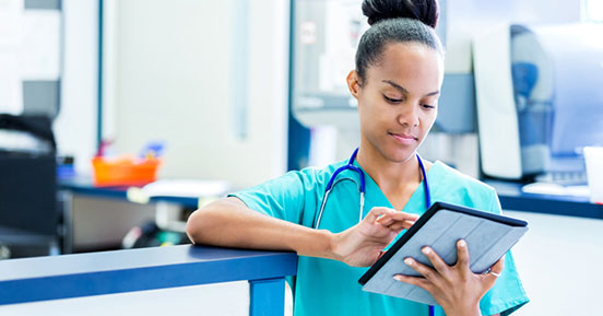 Accelerate Your Transition to the EMR- A medical professional looking at records on her tablet