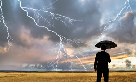 man with umbrella in a lighting storm