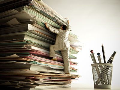 human climbing a stack of files