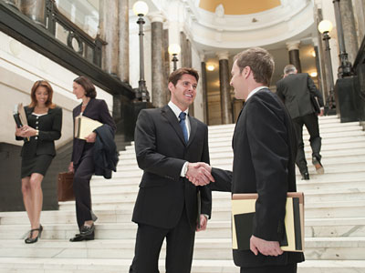 two men shaking hands in a government building