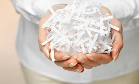 hands holding shredded paper