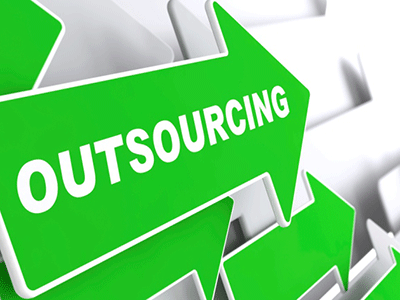 Outsourcing IT-  Outsourcing word on Arrrow board