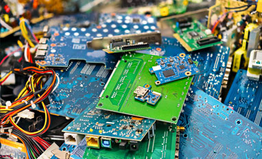  Overcoming Challenges in Recycling Electronics and Secure Media Destruction - E-waste heap from discarded laptop parts 