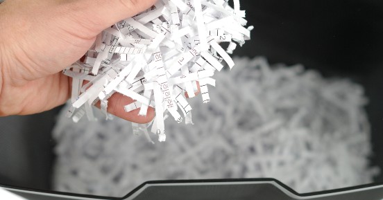 Small Business, Big Secrets: Protecting Your Propietary Information - hand holding shredded paper