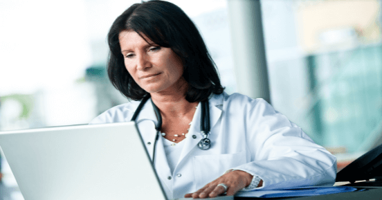 Female doctor working on laptop