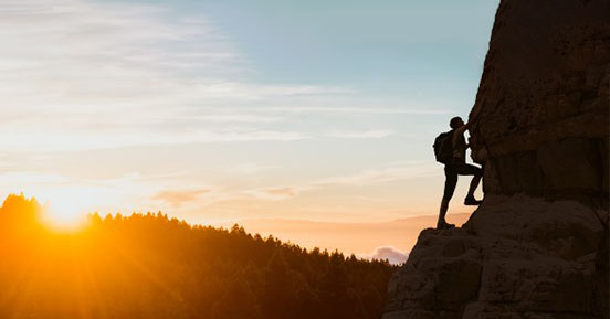 Starting your digital transformation journey on the right step - man climbing a mountain